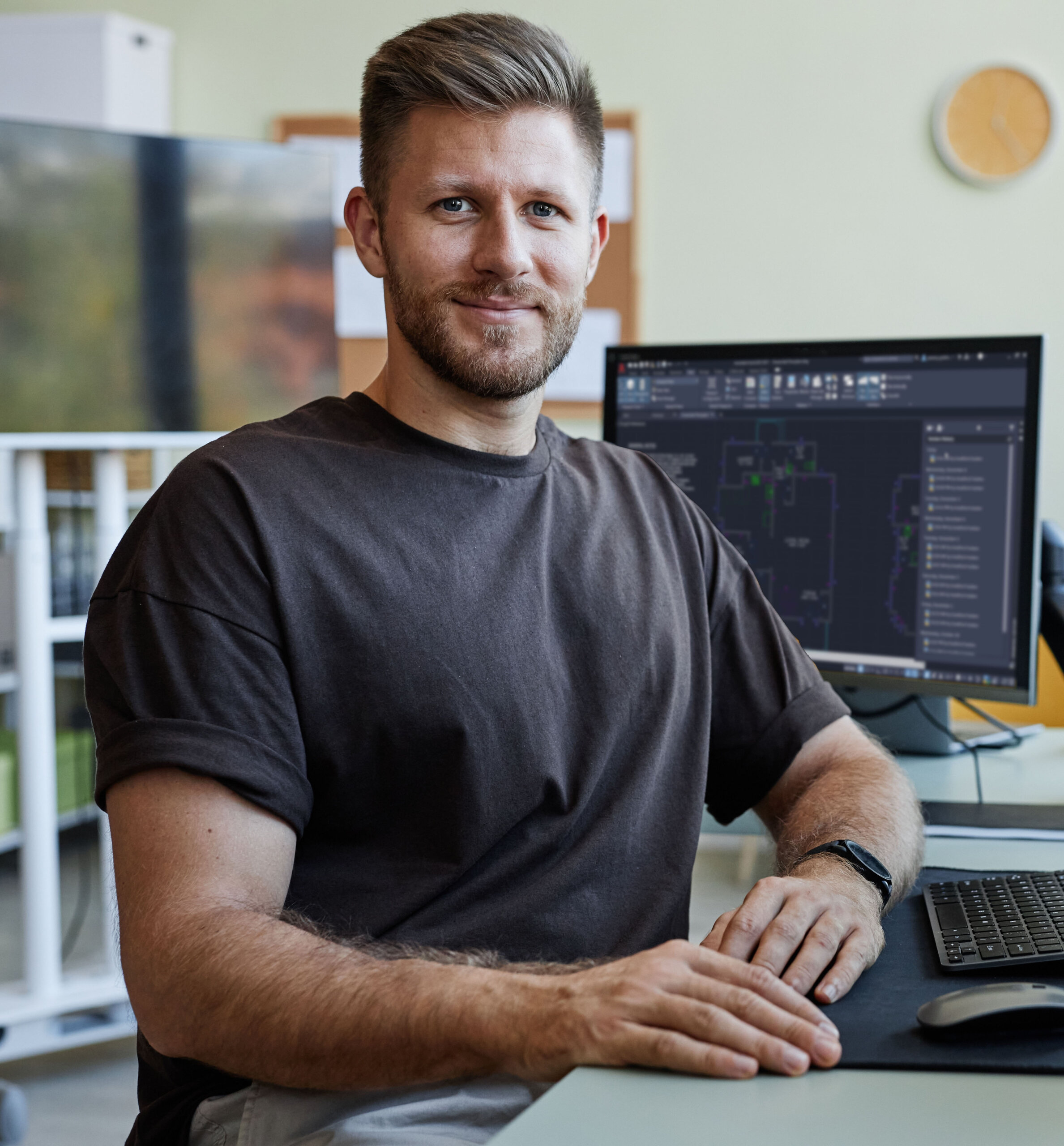 Portrait,of,smiling,software,developer,looking,at,camera,while,sitting